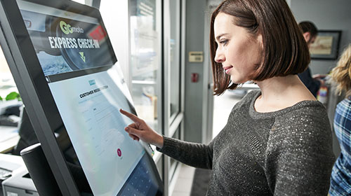 Customer checking in on a kiosk at a dealership.